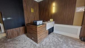 a room with a counter with a television on it at Pensiunea Casa Mitus in Strehaia +36 photos