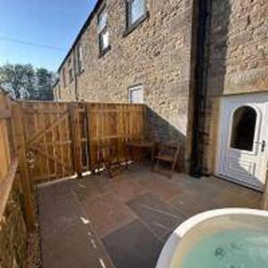 a bathroom with a bath tub in front of a building at Foundry Farm Arch- pod inspired home in Hexham