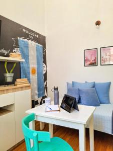 a living room with a table and a couch at LOPEZ Hostel & Suites in Buenos Aires