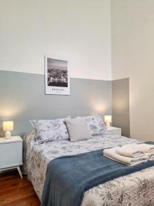 a bedroom with a bed with two night stands and two lamps at LOPEZ Hostel & Suites in Buenos Aires