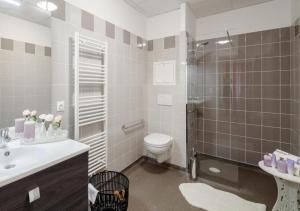 a bathroom with a shower and a toilet and a sink at Zenao Appart'hôtels Suresnes in Suresnes