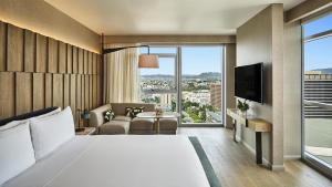 a hotel room with a bed and a large window at Conrad Los Angeles in Los Angeles +246 photos