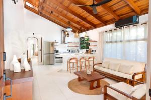 a living room with a couch and a table at Serena Nosara Beach Retreat in Nosara