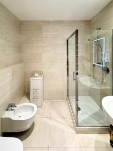 a bathroom with a shower and a sink and a toilet at Romantica SPA Kraków in Krakow