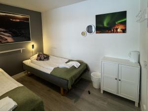a small room with a bed and a small table at Abisko Hostel in Abisko