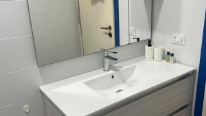 a bathroom with a white sink and a mirror at Agape in Policoro