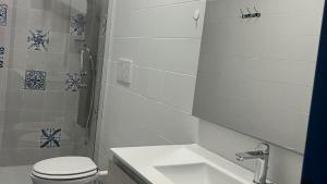 a white bathroom with a toilet and a sink at Agape in Policoro