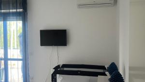 a living room with a tv on a white wall at Agape in Policoro