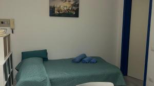 a bedroom with a bed with blue pillows on it at Agape in Policoro +3 photos