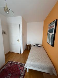 a bedroom with a bed and a painting on the wall at Urlaub am Bodensee in Staad - einmalige Seesicht in Staad