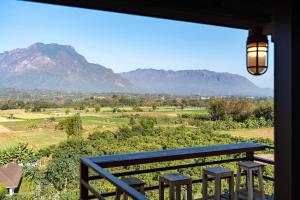 a view of mountains from a balcony with a bench at PATTA Hideaway Chiang Dao in Chiang Dao +43 photos