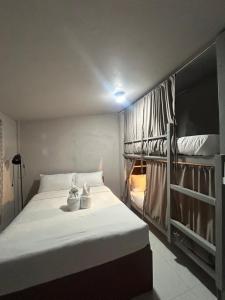 a bedroom with a bed and two bunk beds at Sleep Squad Hostel in El Nido +9 photos