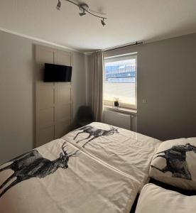 a bedroom with a bed with drawings of deer on it at Upland-Living in Willingen