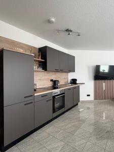 a kitchen with stainless steel appliances in a room at Upland-Living in Willingen
