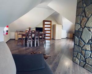 a living room with a couch and a table and chairs at Zielone Zacisze in Krościenko