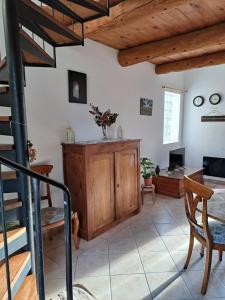 a living room with a staircase and a table and chairs at L'oustalet du Luberon in Cadenet