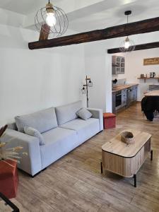 a living room with a couch and a table at Gite Le Reposoir Argoules in Argoules
