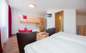 a bedroom with a bed and a desk and a bunk bed at Hotel Restaurant Haus Waldesruh in Eppenbrunn +16 photos