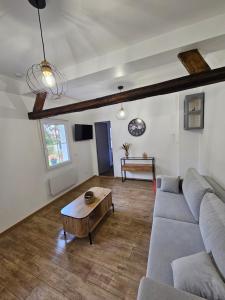 a living room with a couch and a coffee table at Gite Le Reposoir Argoules in Argoules