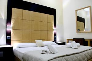 a bedroom with two beds and a large headboard at Hotel Fiorella Milano in Milan +95 photos