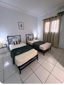 a bedroom with two beds in a room at Villa lina in Midoun
