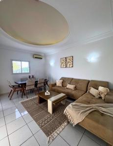 a living room with a couch and a table at Villa lina in Midoun +1 photo