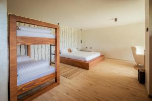 a bedroom with two bunk beds and a chair at Forest by Leni - National Park Salt Pool Villa in Beočin +30 photos