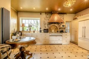 a kitchen with a table and a stove at 4 Bed in Barnstaple oc-n34877 in Tawstock
