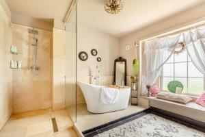 a bathroom with a tub and a shower at 4 Bed in Barnstaple oc-n34877 in Tawstock +35 photos