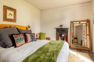 a bedroom with a bed and a mirror at 4 Bed in Barnstaple oc-n34877 in Tawstock