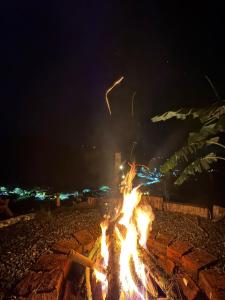 a group of fires in the ground at night at Glamping Villa JuanMa in Salónica