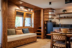 a living room with a bench and a window at Forest by Leni - National Park Salt Pool Villa in Beočin
