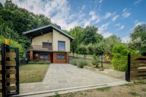 a house with a balcony and a driveway at Forest by Leni - National Park Salt Pool Villa in Beočin