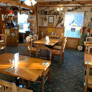 a dining room with wooden tables and chairs at Virginia Creek Settlement in Bridgeport