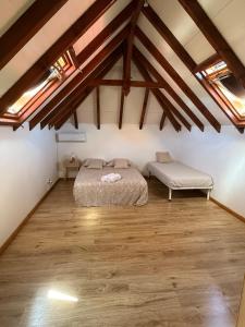 a bedroom with a bed and a bench in a attic at Villa Lolyka in Terre-de-Haut