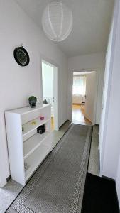 a living room with a white dresser and a hallway at Cozy, new, central in Graz