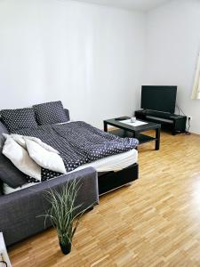 a bedroom with a bed and a table with a laptop at Cozy, new, central in Graz