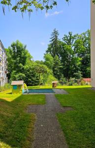 a swimming pool with a slide in a park at Cozy, new, central in Graz