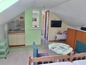 a kitchen and a living room with a staircase at Apartments Bilić in Vis
