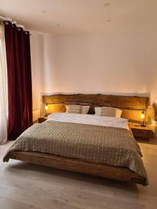 a bedroom with a large wooden bed with two lamps at La Stanca in Cheia