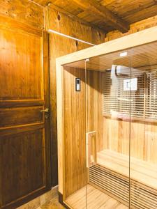 a sauna with wooden walls and a wooden door at Corte Lirice Paradiso in Gioia del Colle
