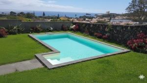 a swimming pool in the yard of a house at Azores Element in Livramento