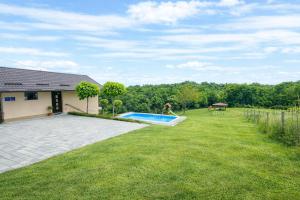 a backyard with a swimming pool and a house at Family Retreat with Pool, BBQ & Green Escape by Destination GREEN Croatia in Praporčan