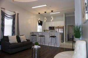 a kitchen and living room with a couch and a bar at Master room w private bathroom 23 in Guttenberg