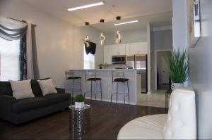 a living room with a couch and a kitchen at Master room w private bathroom 23 in Guttenberg