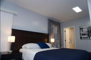 a bedroom with a large bed with a blue blanket at Master room w private bathroom 23 in Guttenberg