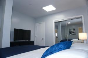 a bedroom with a bed and a flat screen tv at Master room w private bathroom 23 in Guttenberg +12 photos