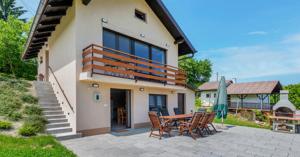a house with a patio with a table and chairs at Family Retreat with Pool, BBQ & Green Escape by Destination GREEN Croatia in Praporčan