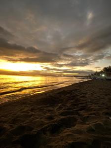 a view of a beach with the sun setting at Lemery farmbeach Escape in Lemery