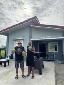 two men standing in front of a building holding balls at Lemery farmbeach Escape in Lemery